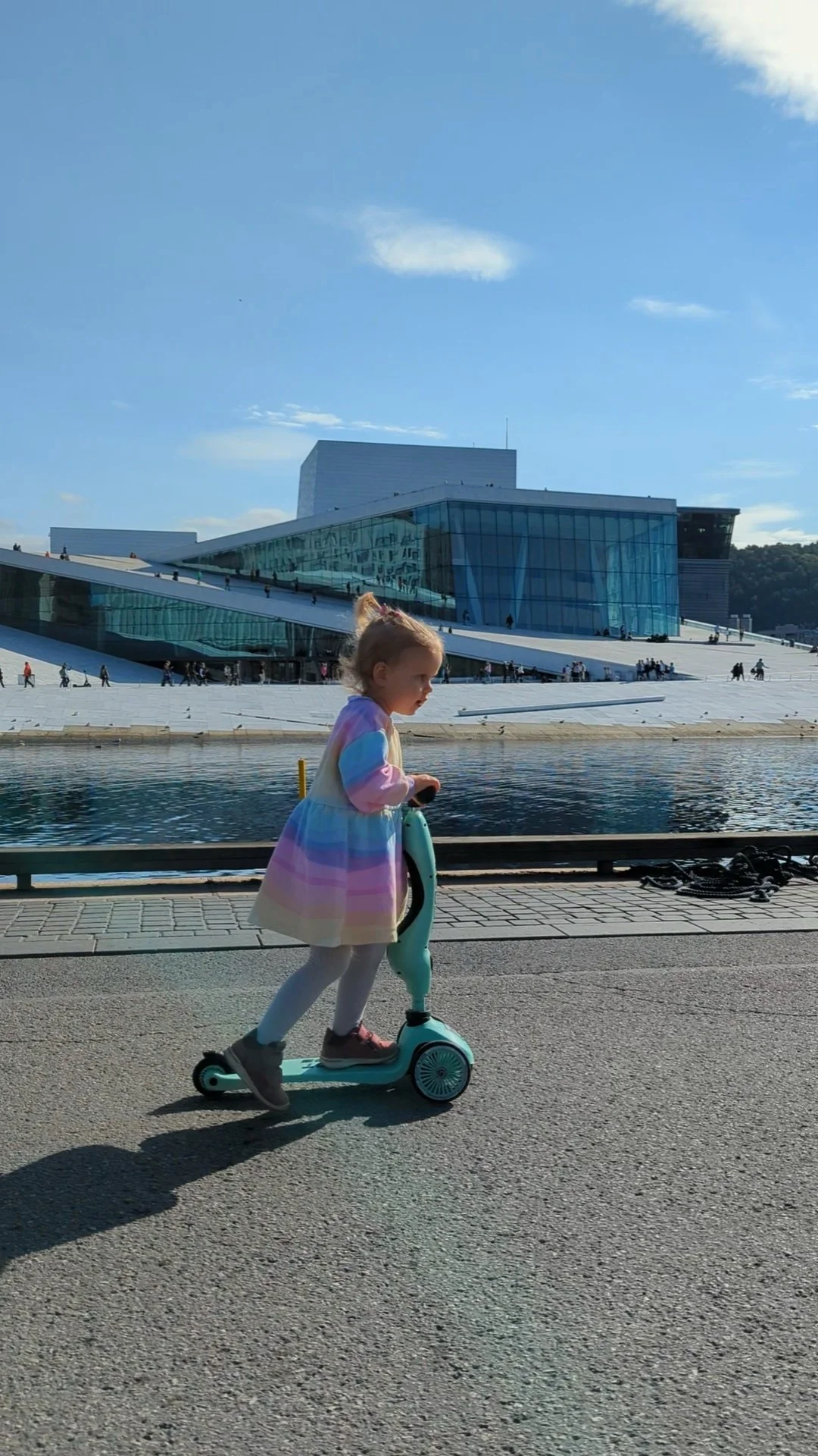 Child scooting by the Oslo Opera House