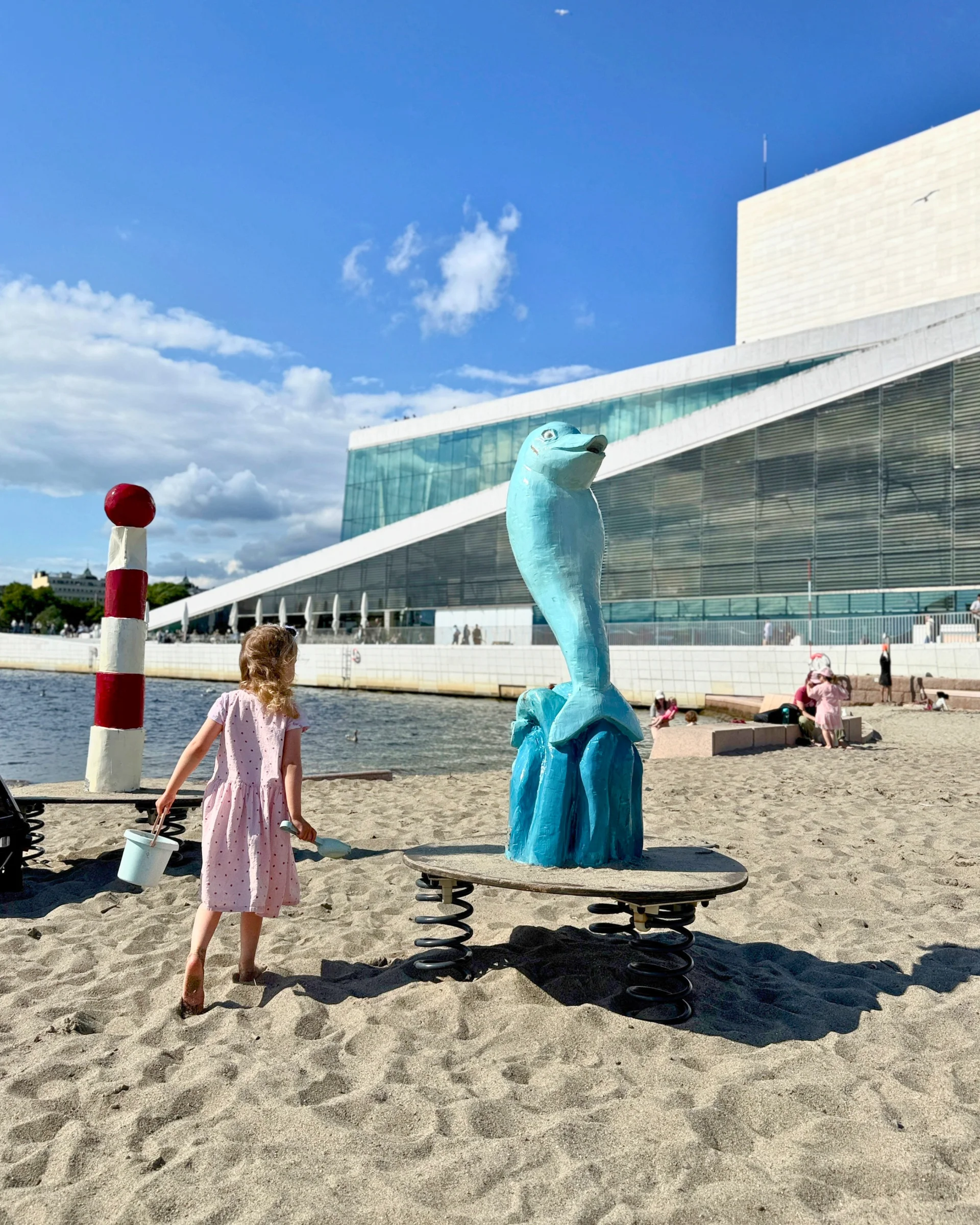 Child scooting by the Oslo Opera House